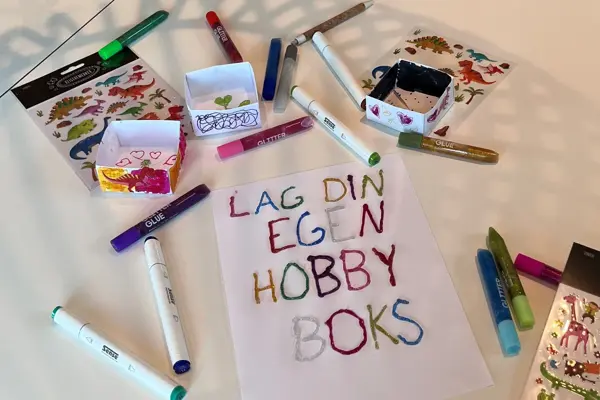 Tusjer og ark ligger på et bord