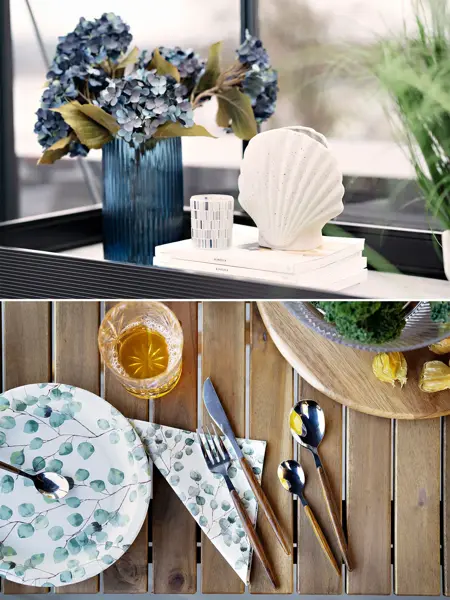 Blå vase med blå blomster, hvit skjellvase og papptallerken med bestikk på et bord.