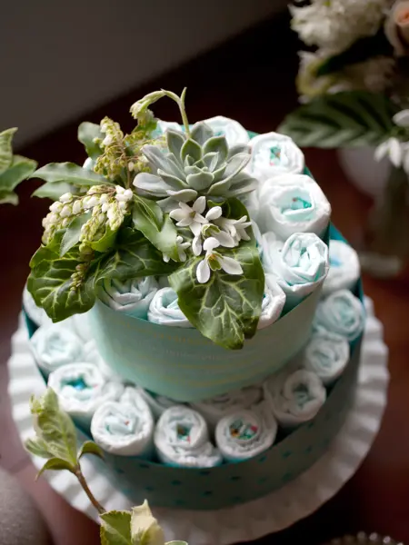A baby shower decoration made of diapers and flowers.