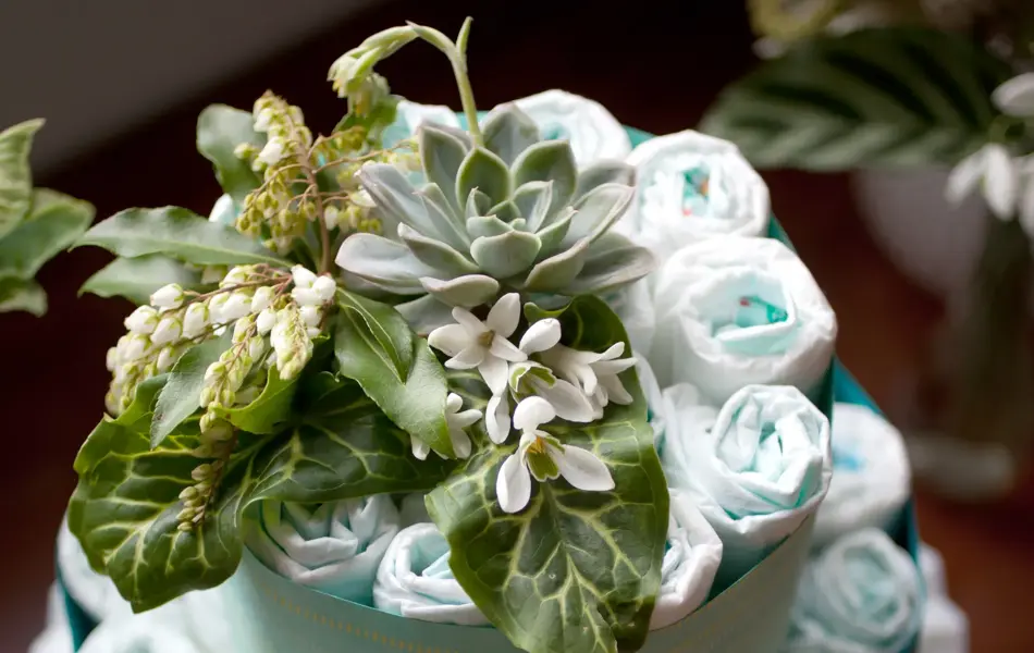A baby shower decoration made of diapers and flowers.