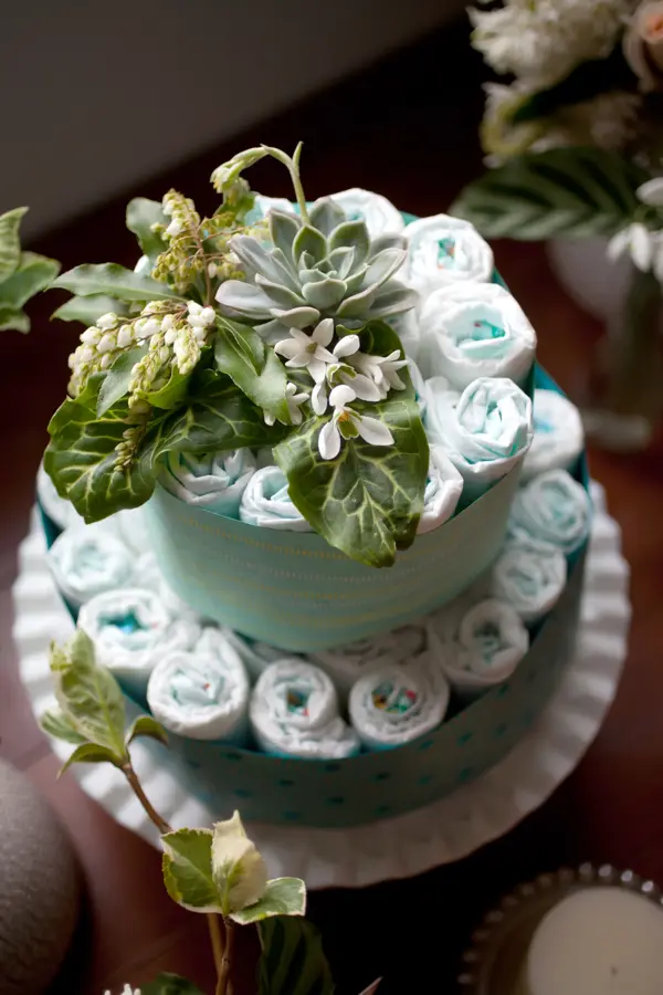 A baby shower decoration made of diapers and flowers.