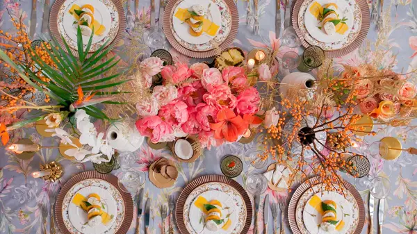Oversiktbilde av bord dekket med fargerike blomster og tallerkener til 6 stykker