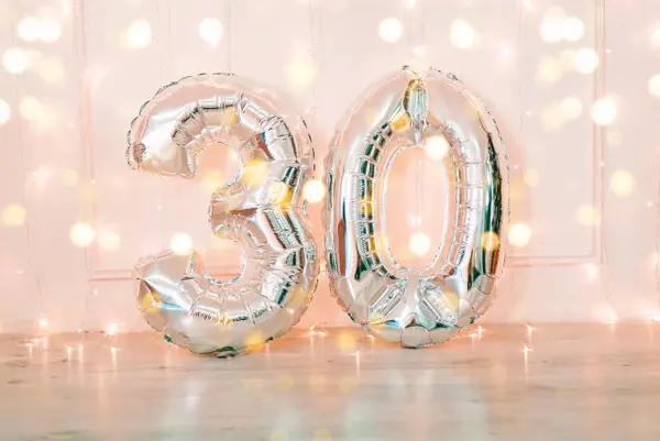 Silver foil birthday balloons number 30 with glitter lights. Birthday concept.