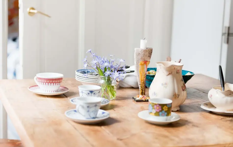 Lilla syriner på hvitt utebord i hagen 