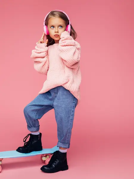 Studio portrait of a cute girl with skateboard