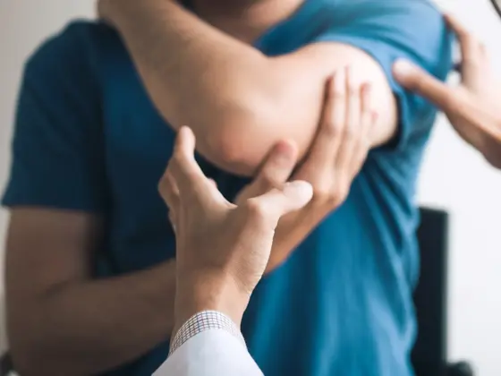 Physical therapists are checking patients elbows at the clinic office room.