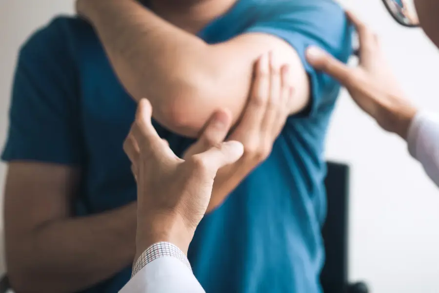 Physical therapists are checking patients elbows at the clinic office room.