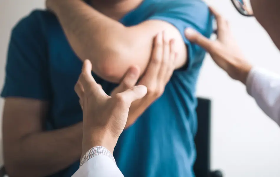 Physical therapists are checking patients elbows at the clinic office room.