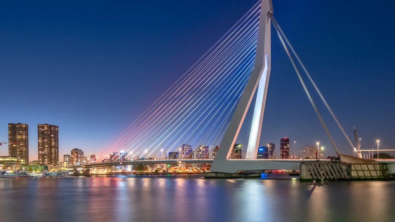 Cityscape and skyline of Rotterdam and Eramsmusbrug at dusk