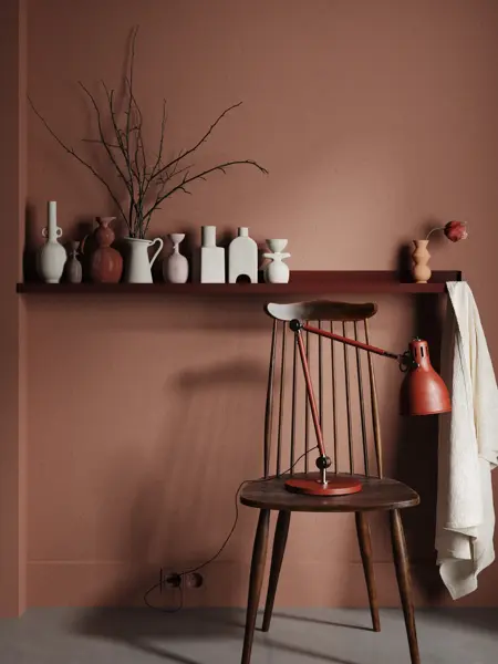 Chair with lamp and vases on shelf close up in dark brown interior, 3d render