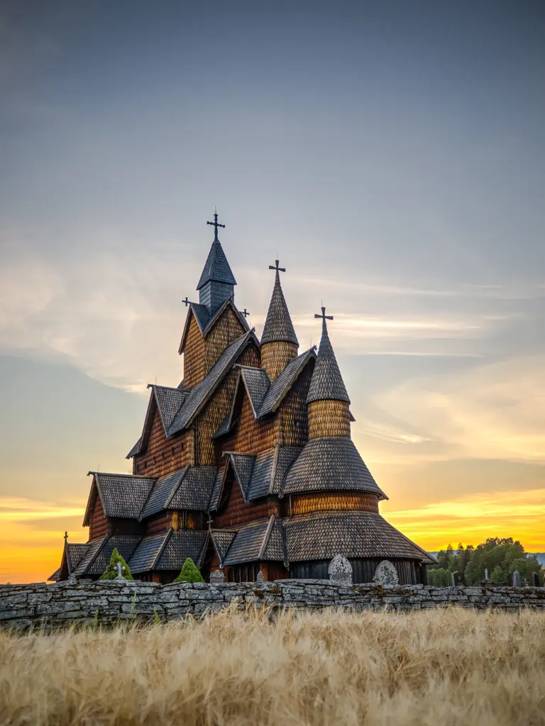 The colossal Heddal stave church looked more astounding as the sun sets on a fine afternoon in Notodden, Norway. The Heddal stave church is the largest and most beautiful stave church in Norway. This triple nave stave church was built in the 1200's and has been restored multiple times.