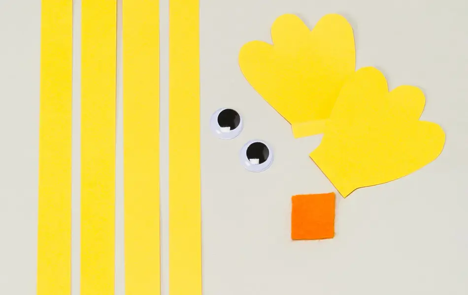 Fire gule papirstriper, to øyne og øvrige ark i gul og oransje