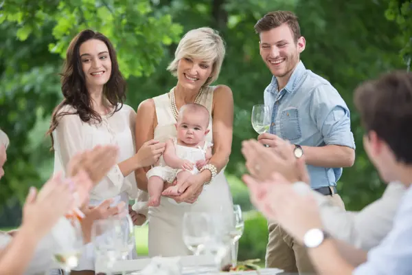Baby being introduced to family during lunch 