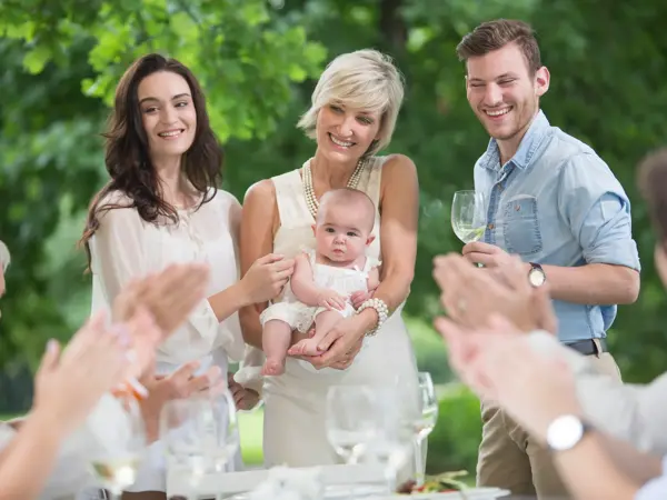 Baby being introduced to family during lunch 