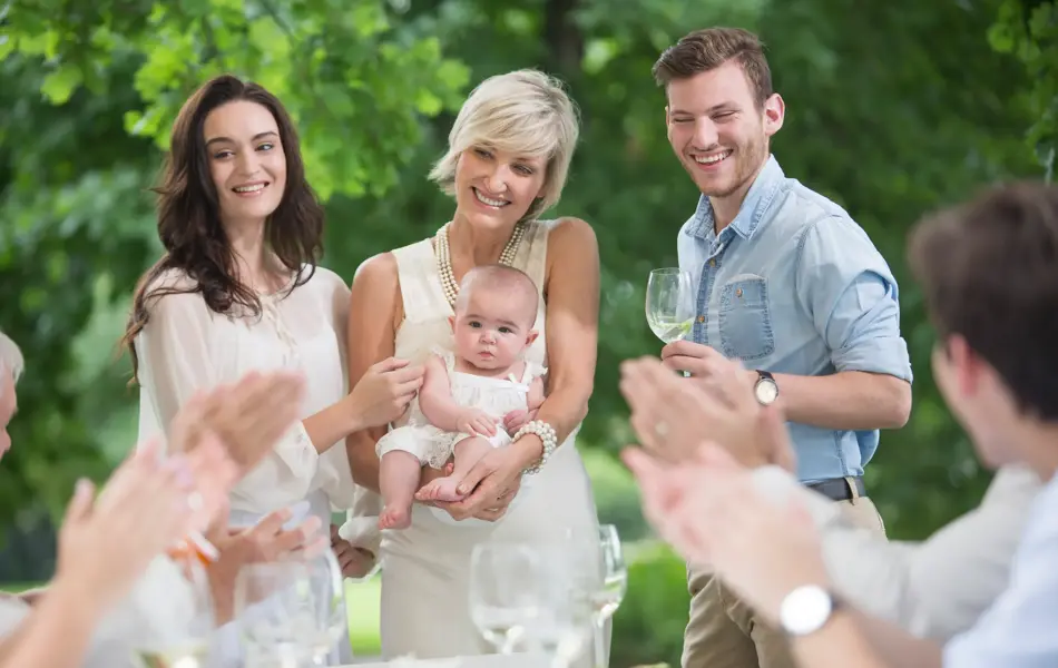 Baby being introduced to family during lunch 