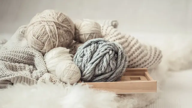 cozy background Wallpaper with a variety of threads for knitting. Close up.