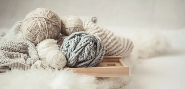cozy background Wallpaper with a variety of threads for knitting. Close up.