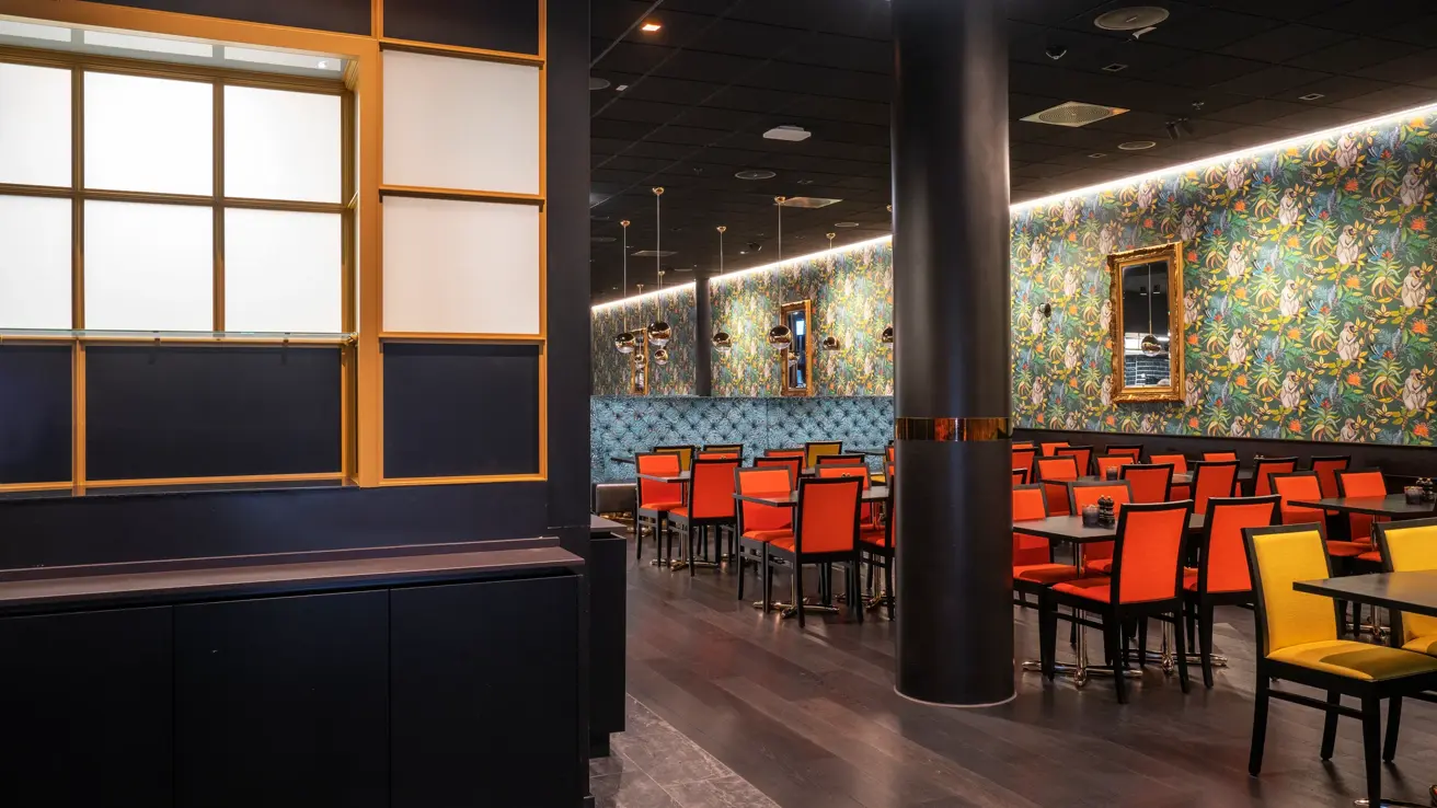 Fargerik tapet, oransje og gule stoler i restauranten på Thon Hotel Storo i Oslo